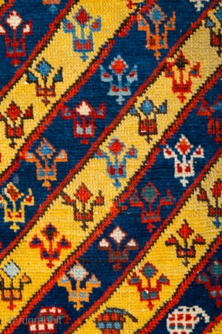 Middle of 19th Century South East Caucasian example, with an yellow and blue field and large rosettes in the white-ground main border, serves as a particularly good illustration of the design affinity  ...