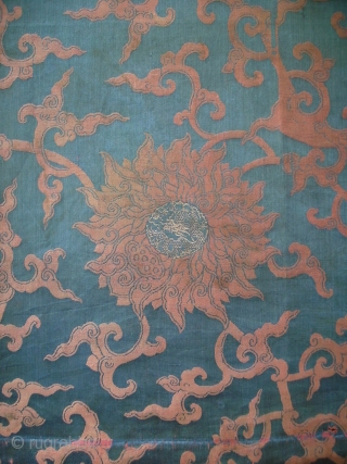 A large size panel of brocaded silk with a pattern of winding flowers. In the hearts of the flowers a climbing dragon. Late Ming or early Qing, ca. 1650. Full width with  ...