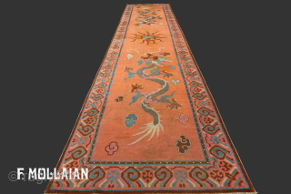 Antique Khotan Rug | contact: info@mollaianrugs.com |


An antique Khotan runner, East Turkestan
Size, approx: 530cm. x 120cm
The soft burned-orange field with two large Imperial Dragons facing each other and chasing framing pearl. In  ...