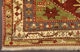 A fine Kazak rug, South Caucasus.

The abrashed deep rust field with various angular floral motifs and hooked panels around double hooked octagon medallions containing hooked bars, Green stellar flower head and animal  ...