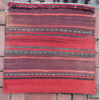 Baluch Pile Bag circa 19th century-- approx 24 × 24” --Repetitive small diamonds on indigo field. The “dollar sign” border is a rare feature used only by a small population of Baluchistan  ...