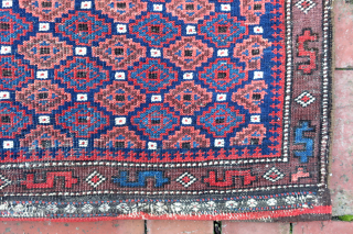 Baluch Pile Bag circa 19th century-- approx 24 × 24” --Repetitive small diamonds on indigo field. The “dollar sign” border is a rare feature used only by a small population of Baluchistan  ...