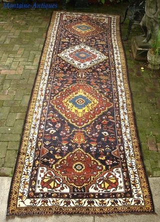 Bahktiari Gallery Runner-- 4 ft 5 in x 14 ft 2 in. Brown wool foundation. slightly flairs at the ends. Aside from this-- a very dynamic old rug in very good condition.  ...