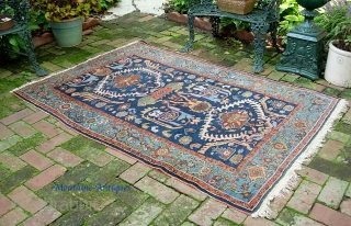 West Persian Tribal rug 4 ft 2 inches x 6 ft 0 inches. Can anyone identify this strange smiling animal? Looks like maybe a cat with a bird sitting on his shoulder??  ...