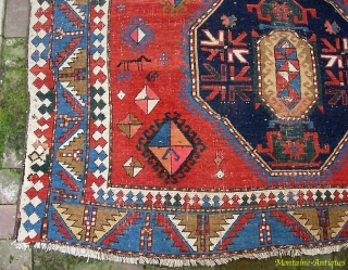 Kazak, 5.3 by 7.7. Circa 19th century.  Possibly Armenian with various inscriptions. There are two hot colors applied sparingly on one side of the rug.  Various old repairs and reweaves.  ...