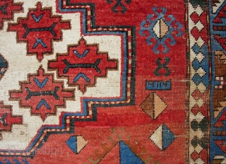 Kazak, 5.3 by 7.7. Circa 19th century.  Possibly Armenian with various inscriptions. There are two hot colors applied sparingly on one side of the rug.  Various old repairs and reweaves.  ...