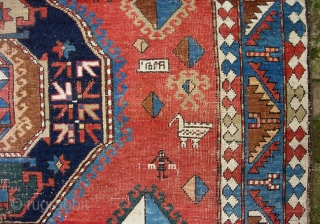 Kazak, 5.3 by 7.7. Circa 19th century.  Possibly Armenian with various inscriptions. There are two hot colors applied sparingly on one side of the rug.  Various old repairs and reweaves.  ...