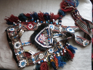 Southwest of Persia- Qashkai animal trapping- head wear. Cowry shells, buttons and other ornaments with tassels with an old Qashkai strap.            