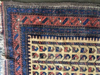 Unique Antique Baluch rug. Early example. Worn condition with some knots showing. All colors derived from natural dyes. Natural camel hair field containing several rows of the tree of life/bird design. Size:  ...