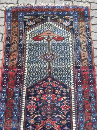 A lovely Persian Bakhtiary long rug displaying two cool looking gentlemen in the centre, size: ca. 345x100cm / 11'3''ft x 3'3''ft , signed and dated at the top. Sides and ends not  ...