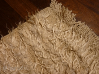 Luxurious, understated filikli tulu from Karapinar, 170x110cms, undyed soft, shiny angora wool tufts on undyed sheep wool plainweave base.              