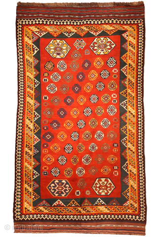 An exquisitely woven antique Qashqai kilim from southwest Iran. The central motifs, the emblem of the Qashqai tribe, is beautifully repeated across the rich terracotta field. The color transitions diagonally, creating a  ...