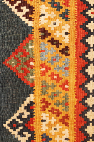 An exquisitely woven antique Qashqai kilim from southwest Iran. The central motifs, the emblem of the Qashqai tribe, is beautifully repeated across the rich terracotta field. The color transitions diagonally, creating a  ...