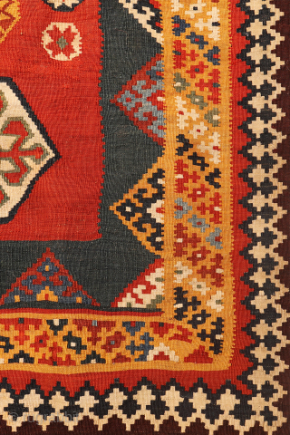 An exquisitely woven antique Qashqai kilim from southwest Iran. The central motifs, the emblem of the Qashqai tribe, is beautifully repeated across the rich terracotta field. The color transitions diagonally, creating a  ...