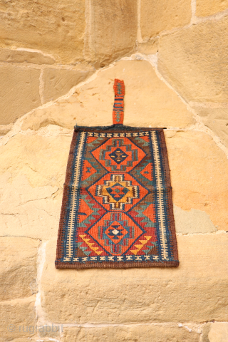 A rare Kurdish bag that has been opened out. This chanteh originally was folded in halve resulting in a square bag. The rectangular long and narrow strip was used to close the  ...