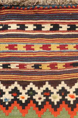 This highly collectible antique Qashqai kilim from Iran features a bold and captivating design. Made with top-quality natural dyes, it showcases rich, deeply saturated colors—including striking greens and blues—that sets it apart.

At  ...