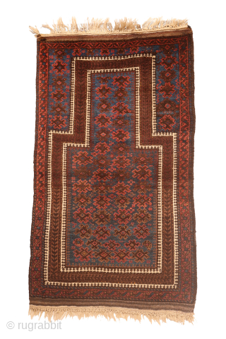 A beautiful antique Baluch prayer rug with a lovely deep blue colour. The main motifs apper to be floating in the main field. The sheeps wool is soft, shinny and glossy. The  ...