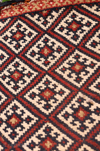 A neat chantah or bag  woven by a Qashqai woman from South West Iran. The pattern is a grid that occupies the whole surface of the bag, with only two borders  ...