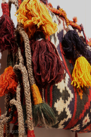 A hard to find Arabic baby craddle. This extraordinary little kilim was used as a hammock whilst the mother was weaving, cooking, tending the herds etc. The long tassels had a double  ...