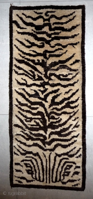 rare and nice drawn tiger skin design rug. the white and brown is undyed wool. this is not a tibetan weaving but it was made for a tibetan monastery. condition is good  ...