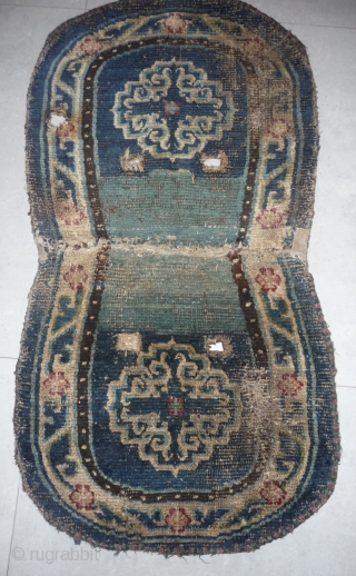 great ancient tibetan saddle with narrow white border, the medalions display an early design. Tibet early 19th century or before.             