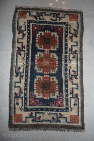 19th century small sized tibetan rug with white border, nice  natural dyes and quite good pile. tibet, approx 110x 65cm.            