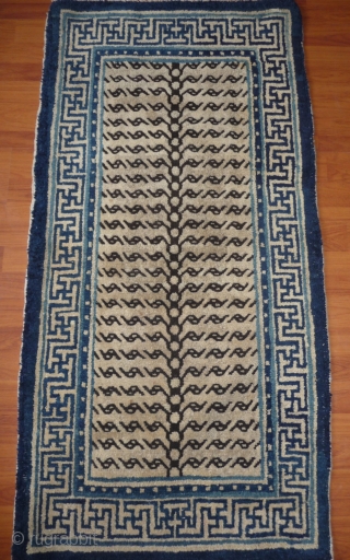 chinese white ground tiger rug in very good condition! few knots redone is the blue outer guard border. not  common for this region, probably baotou area rug. china late 19th c. 