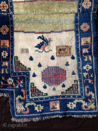 late 19th century tibetan white ground saddle rug with very nice all natural colors,. very good condition,super fine wool and very tight knotting. abrashed light green center and deeper green corners..  