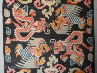 old tibetan khaden showing together the most popular motifs since the late 19th c. as dragon, tiger, lion and rarer seen on rugs garuda. 
according to a probably first third 20th c  ...