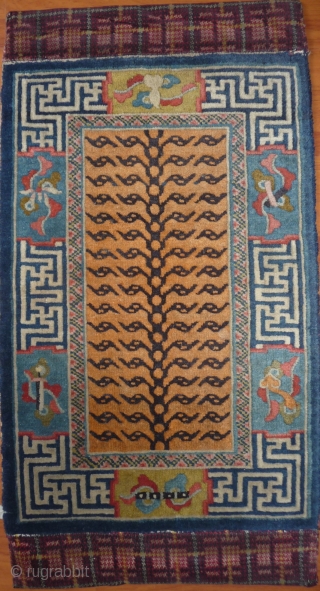 a very special chinese small tiger rug made probably in northeast china for northwest china, as it cames  some years ago out of a buddhist monastery in the qinghai province (possibly  ...
