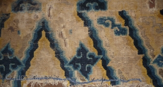   FRAGMENT OF THE BOTTOM OF A NINGXIA TEMPLE HANGING OR PILLAR RUG WITH SOME UNUSUAL DESIGN FEATURES. CHINA LATE 18TH C.          