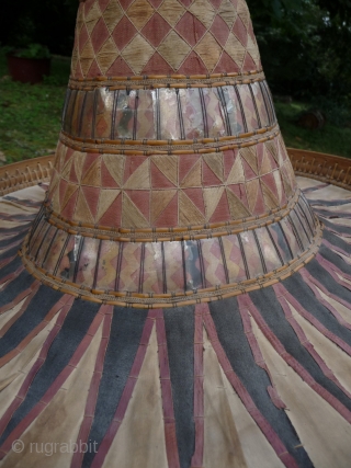 this is a beautiful and rare antique indonesian hat from the south sulawesi. it is made of palm leaves, decorated with pieced cloth and embroidery.the round base is perhaps bambu. please note  ...
