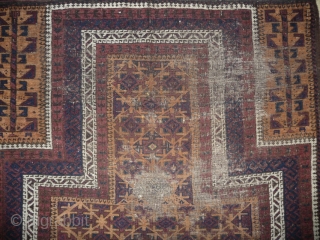 beautiful baluch prayer rug with prayer wear.attrativ hand panel and turkmen field design with a strong reciprocity effect.lots of interesting small amulets. all natural colors with very nice apricot ground color.silk highlights  ...