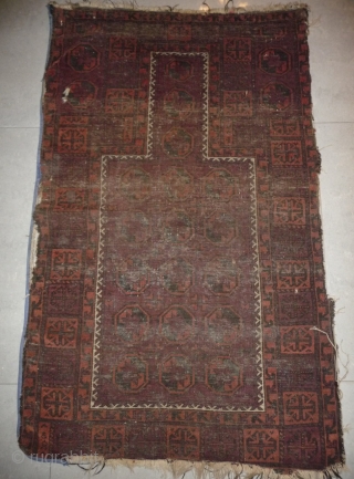 one of the rare baluch pieces found in tibet.a prayer rug with a simple design made with 2  natural dyed and 2 undyed colors, but not without its protectiv amulets. nice  ...