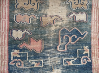 all about clouds. an early 20th century tibetan popart rug with an abrashed green sky background. damage but a funny unique piece; note the integration of a cloud design in the traditional  ...