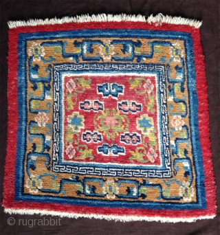 nice tibetan mat around 1900 with nice all natural colors including the light pink; beautiful gold yellow and green..uncommon center drawing and design element right and left... superb condition with high pile  ...