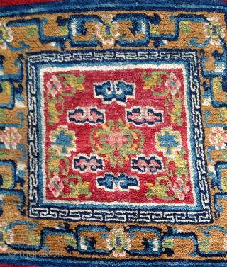 nice tibetan mat around 1900 with nice all natural colors including the light pink; beautiful gold yellow and green..uncommon center drawing and design element right and left... superb condition with high pile  ...