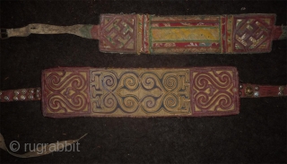 2 old tibetan belts, one very nice one.. leather textile and embroidery and other metal decorations. what looks like "recycled batteries" are just hole metal buttom. the buckle of the biggest belt  ...