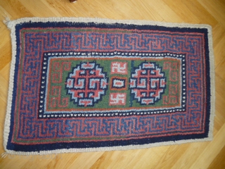 A "Wangdan", 19th century Tibet little rug.  Size is 27 X 42 inches. Perfect condition and unusual weave - see shot or reverse.         