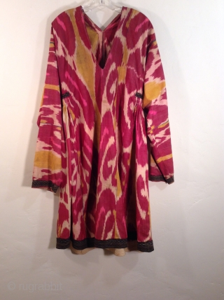 This is an Uzbek ikat silk dress with very traditional colors.  It is in very good condition and would fit a large woman.         