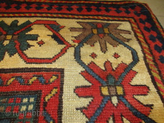 This circa 1880 Kazak Rug #8203 measures 3‘6“ by 6‘5“. It is a so-called ‘Star Kazak’. It has a red ground with nine small white crosses at the bottom of it and  ...