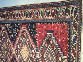 This antique Shirvan #7853 dated 1913 in five places measures 4’0” X 5’9”. The field of the rug is divided into thirds. The top and bottom third have a red ground. The  ...