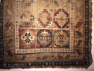 Early Caucasian (140x95 cms)Small perfectly worn out complete rug it also has brindled (camel?) warps and a very interesting Memling gul.            