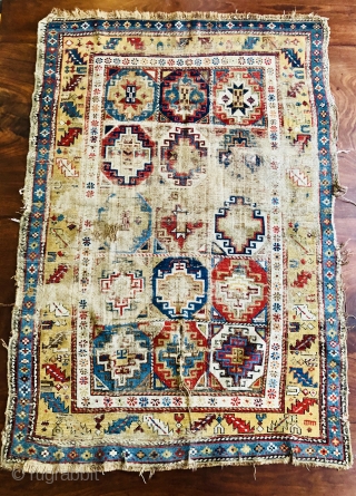 Early Caucasian (140x95 cms)Small perfectly worn out complete rug it also has brindled (camel?) warps and a very interesting Memling gul.            