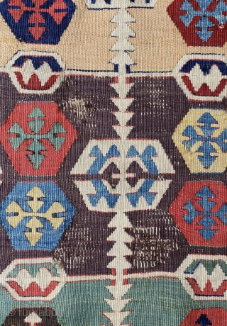A very old, originally two-panel kilim woven in wonderfully rich and luminous colours. The surviving section constitutes the inner field part of one half panel.The field design consists of an endless repeat,  ...