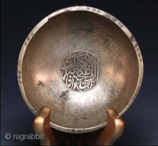 A Mughal Deccan bronze calligraphic bowl, India, Golconda or Bidar, 16th century of squat round bowl form, an engraved Arabic calligraphic around the bowl, the spherical base encircled by a splayed ridge,  ...