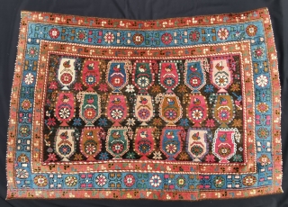 Fragmented Caucasian carpet....now a Boteh parade in "chuval" format. Brilliant colors including a light and darker camel hair. 133 x 92 cm           