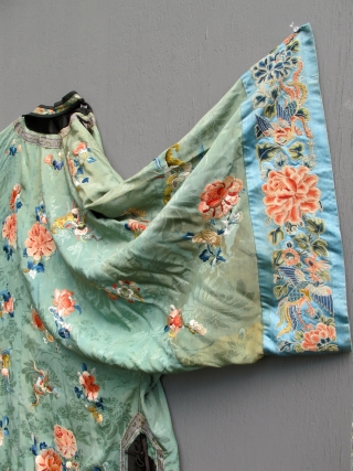 A finely embroidered XIXth C. Chinese green silk robe.                        