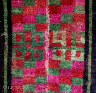 Mat, Tibet, early 20th century, cm 70x55. Tibetan rugs in so-called ‘tsuk-truk’ technique (woven in narrow stripes - then joined - on small back strap looms) are probably the survivors of a  ...