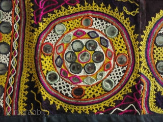 This is a traditional embroidery from Kutch, India and designed a wall hanging in desert Tharparkar, Pakistan. Totally hand embroidery with mirror-work. Its approximately size is 48"X8".      